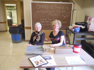 Committee members Marcia Nolan and Rose Roy helping at the event