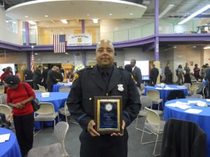 Patrolman Xavier Lynch, a 20 year veteran of the Cleveland Division of Police, displays his Cleveland Police Foundation's Community Service Award, for his outstanding service to both the citizens, and children of the 5th District. Officer Lynch also received The Commander's Commendation Award on this night.