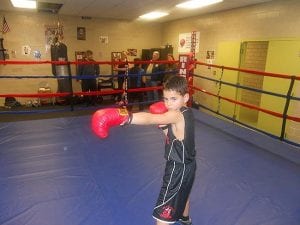 Boxing trainee Jonah Boyles shows his style in the Estabrook Recreation Center's donated boxing ring.
