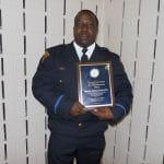 Detective Anthony Spencer displays his Community Service Award.
