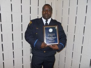 Detective Anthony Spencer displays his Community Service Award.
