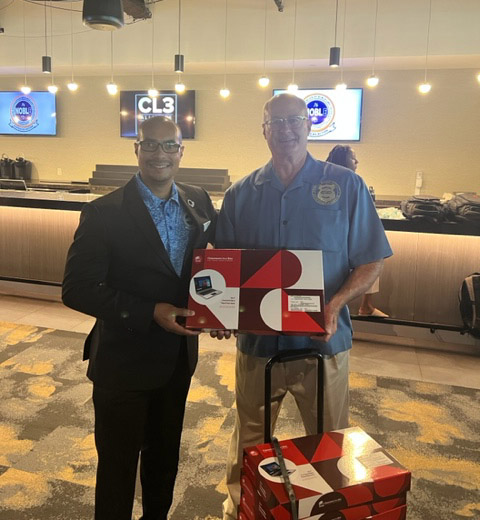 CPF Executive Director Rick DeChant presents NOBLE Cleveland Chapter President Thomas McMillan with the laptops from MCPC for the top student performers at the workshop.
