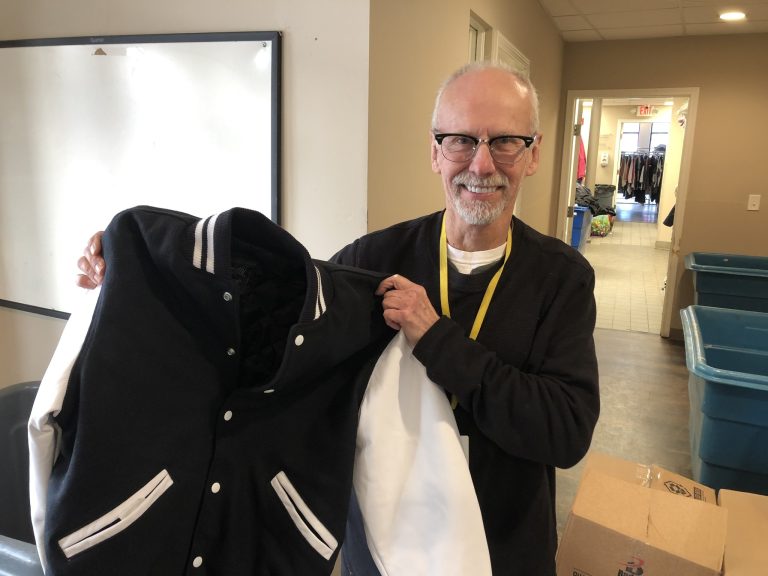 Second District resident and business owner Mike Duda with one of his donated Jackets from Sports Focus