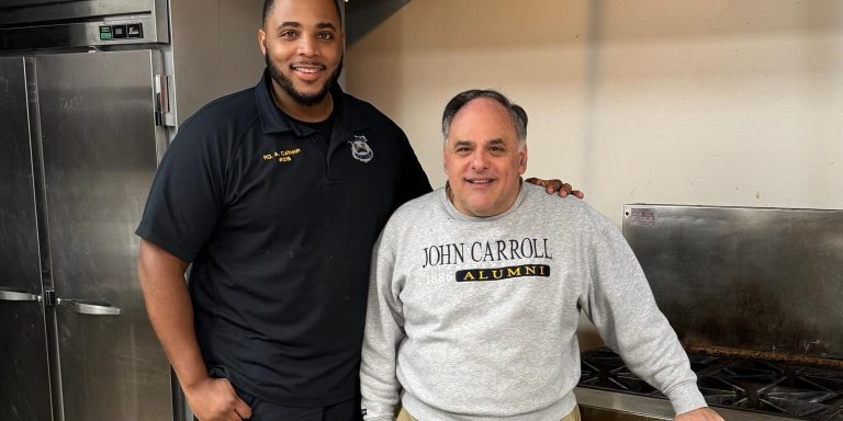 Officer Calhoun with Father Previte of Holy Rosary Catholic Church