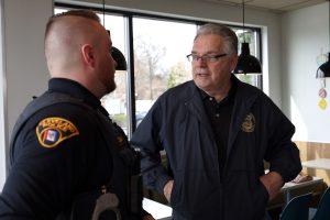 Bob Guttu speaks with a Cleveland Police officer during Coffee with a Cop at McDonald’s in Westpark.
