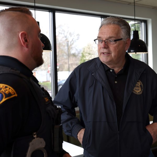 Bob Guttu speaks with a Cleveland Police officer during Coffee with a Cop at McDonald’s in Westpark.