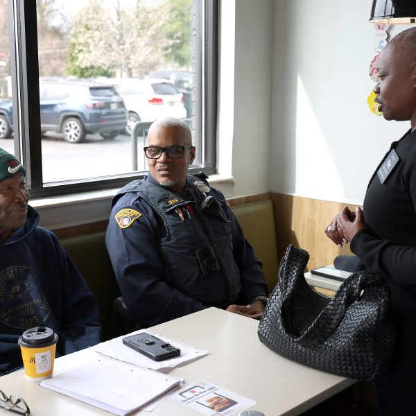 Community members talk with Cleveland Police officers at a booth during the Coffee with a Cop event.