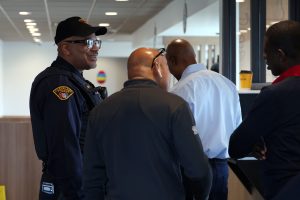 A Cleveland Police officer laughs while engaging with attendees in line at McDonald’s.