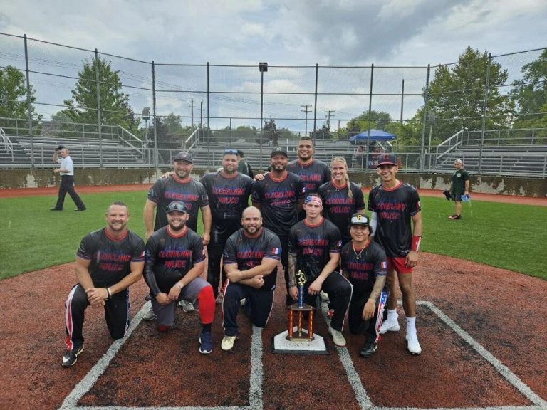 Members of the Guardians of Hope softball team pose on the field following a past tournament.