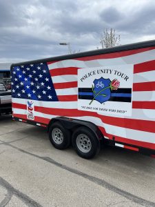 Side view of the trailer with Police Unity Tour and Flags of Freedom logos visible.