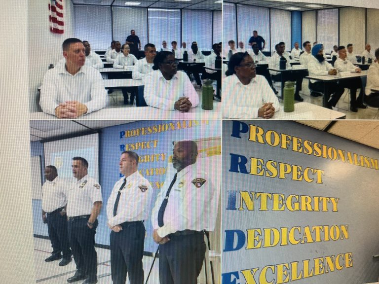 Guttu and CPD leadership speak with cadets of the 156th Cleveland Police Academy Class at the Justice Center, with a “PRIDE” values wall behind them.