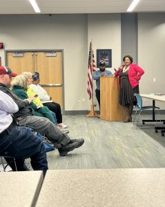 Councilwoman Howse-Jones speaks at the podium alongside a fellow city representative.