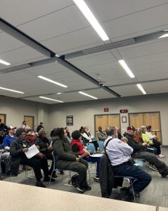Community members seated and listening during the April District 3 Policing Committee meeting.