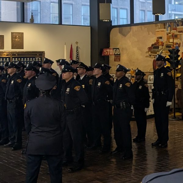 The 156th Academy Class stands at attention during their badge pinning ceremony inside the Police Museum’s main hall.