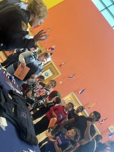 Students and families engage with CPD at an informational table
