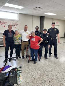 District 2 officers pose with smiling senior participants following the breakfast and CPOM presentation.