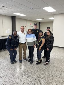 District 2 officers and staff gather with several Hispanic Senior Center members for a casual group photo.