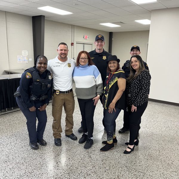 District 2 officers and staff gather with several Hispanic Senior Center members for a casual group photo.