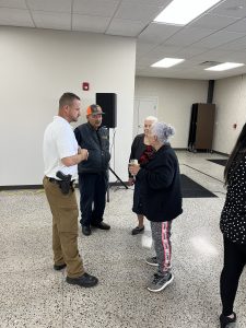 Commander Tim Maffo-Judd chats with several seniors during the appreciation event at the Hispanic Senior Center.