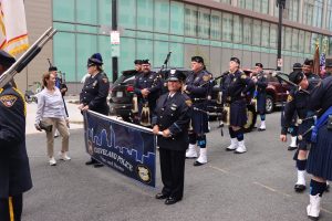 CPD banner holders and pipers prepare to step off as the group gathers at staging area