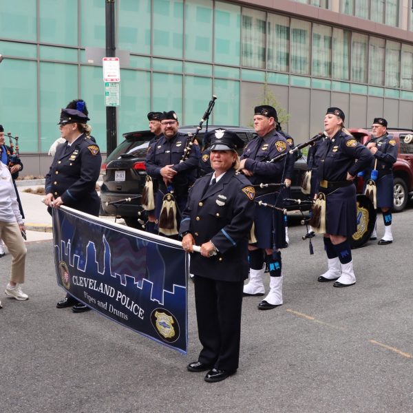 CPD banner holders and pipers prepare to step off as the group gathers at staging area