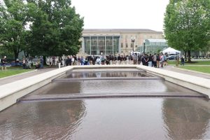 Crowd gathers near a reflecting pool outside the National Law Enforcement Museum during National Police Week