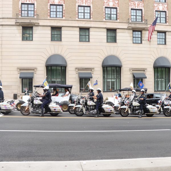 Motorcycle officers ride in formation during a memorial procession