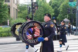 Cleveland Police drummer leads the Pipes and Drums section through a crosswalk in D.C.