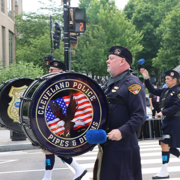 Cleveland Police drummer leads the Pipes and Drums section through a crosswalk in D.C.